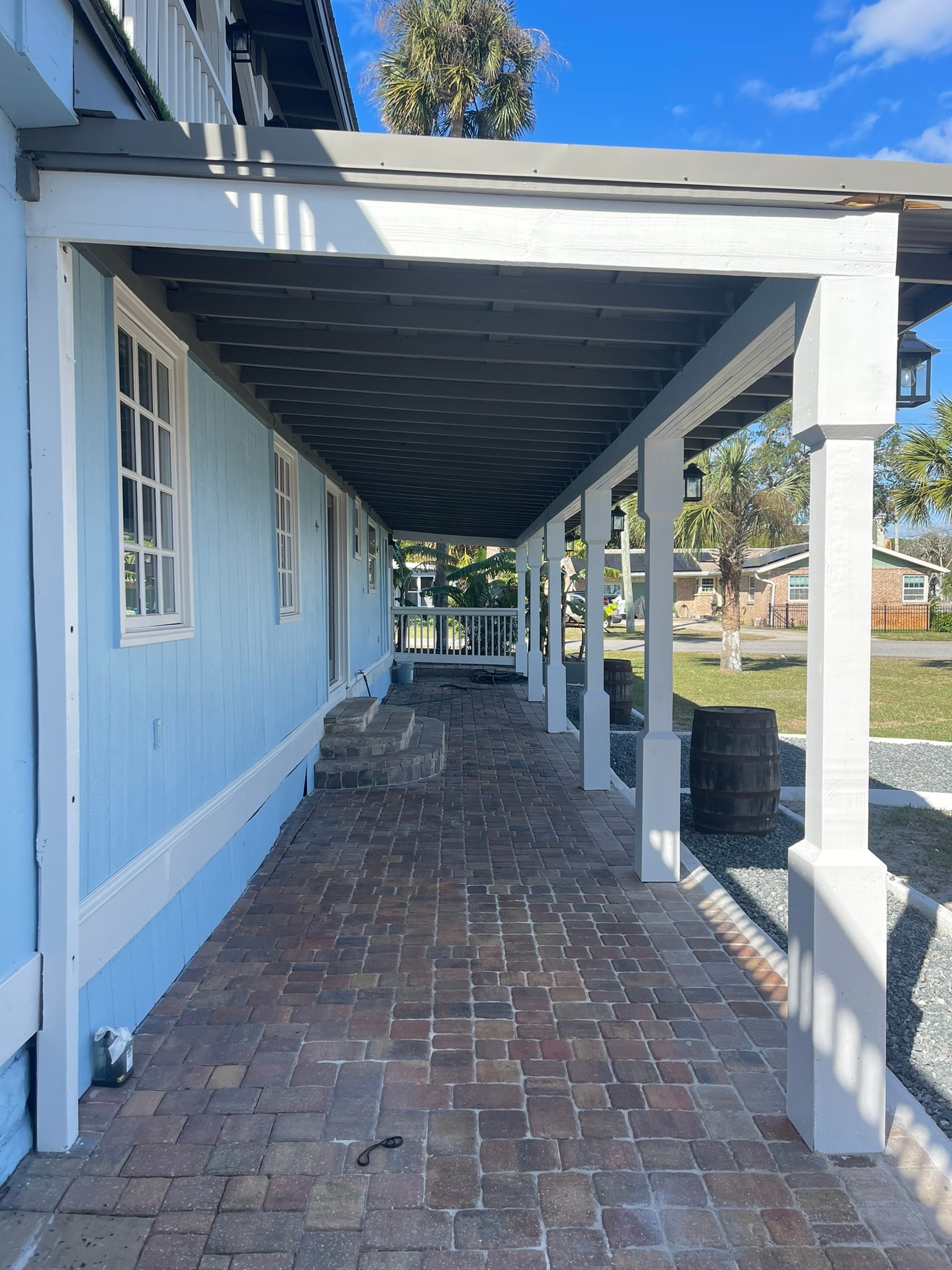 McCoy House renovation in progress — new exterior siding and porch framing